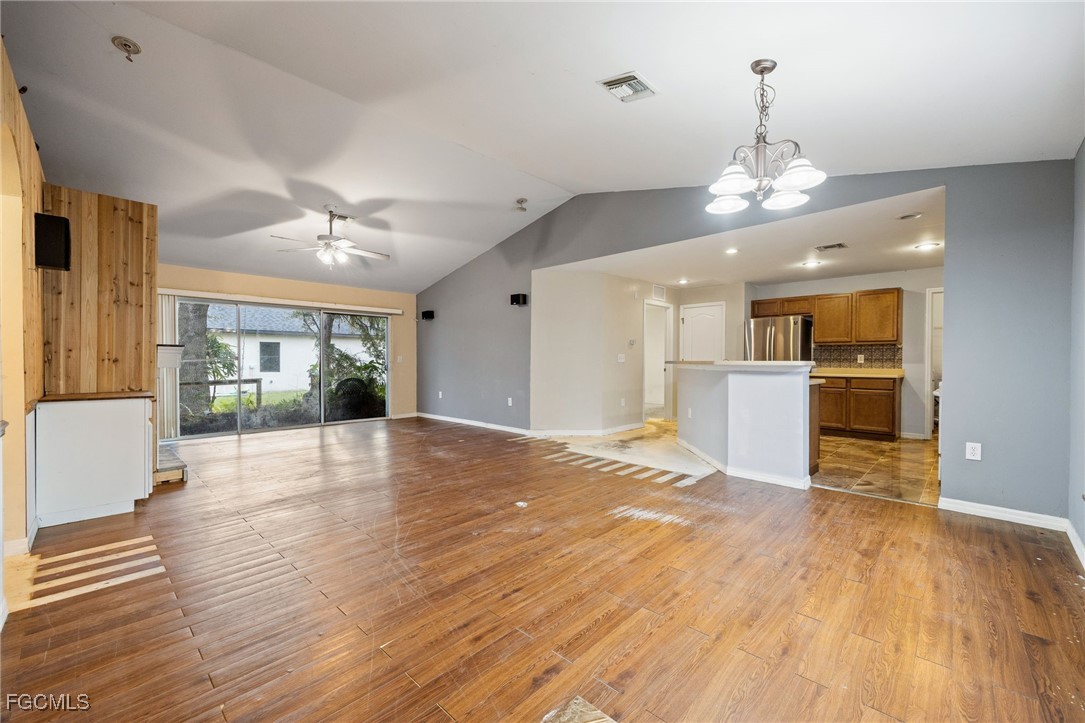2406 East 23rd Street Alva, FL 33920 - Photo 4 of 33 a view of a livingroom with a furniture wooden floor and kitchen view