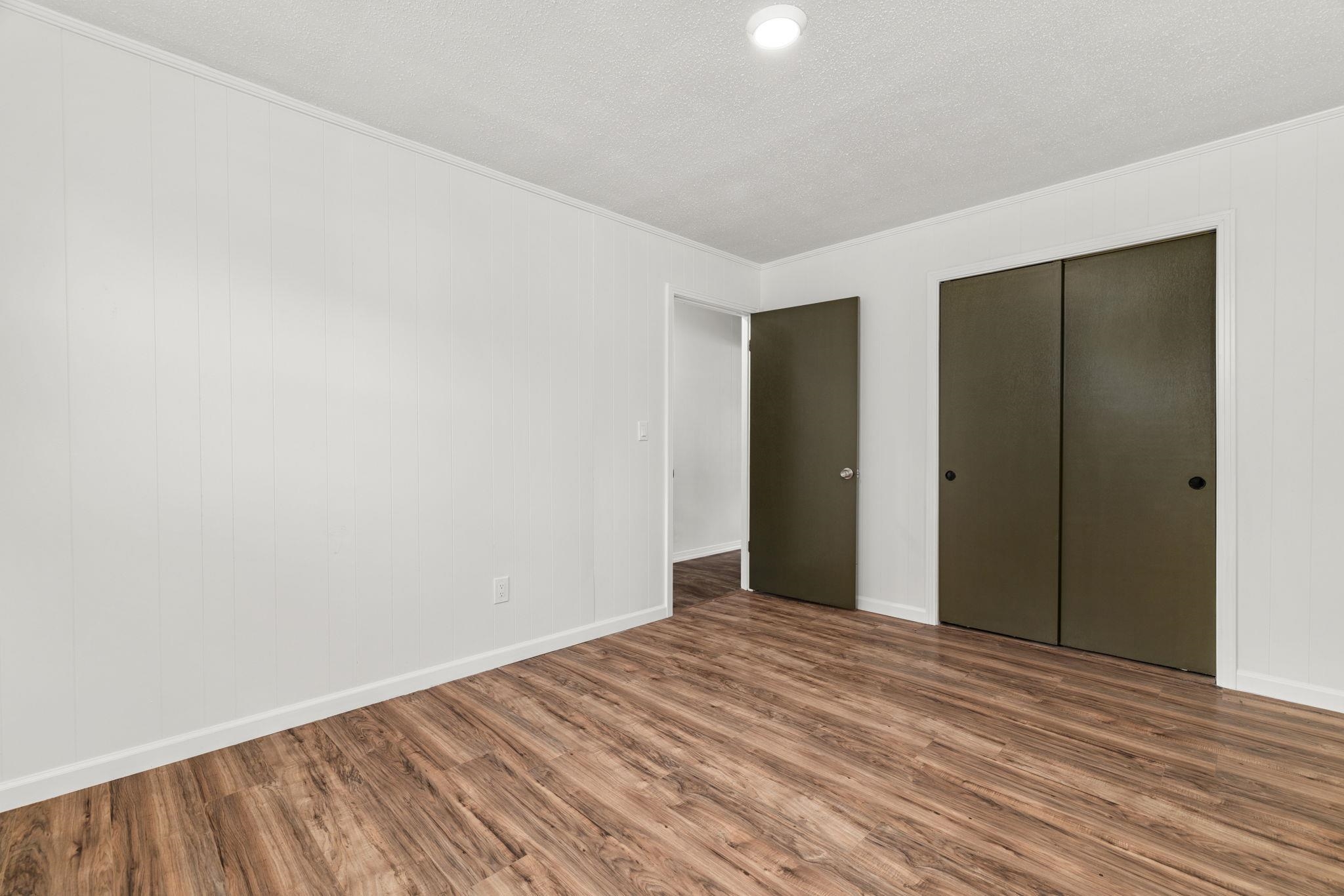 217 Red Bay Road Golden, MS 38847 - Photo 16 of 33 Room featuring wood-finish flooring, white vertical paneled walls, and a recessed ceiling light