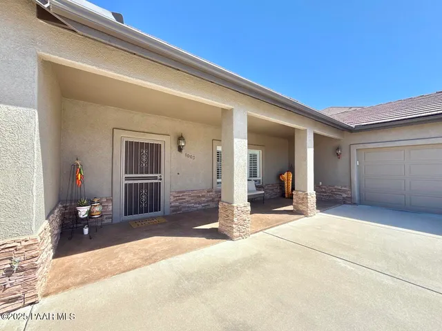 a dining room with furniture a chandelier and wooden floor