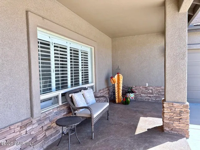 a living room with furniture a flat screen tv and kitchen view