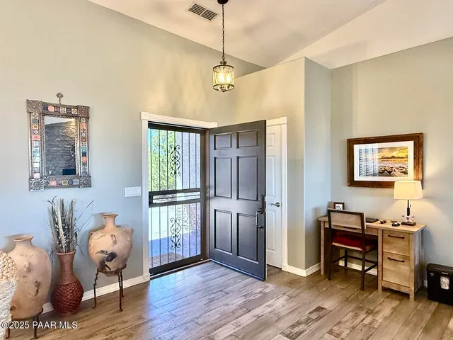 a living room with furniture a ceiling fan and a rug
