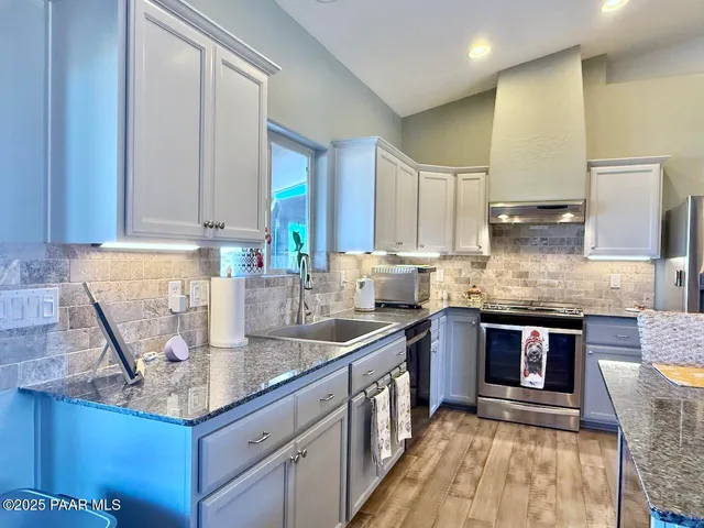 a bedroom with a large bed and a chandelier fan