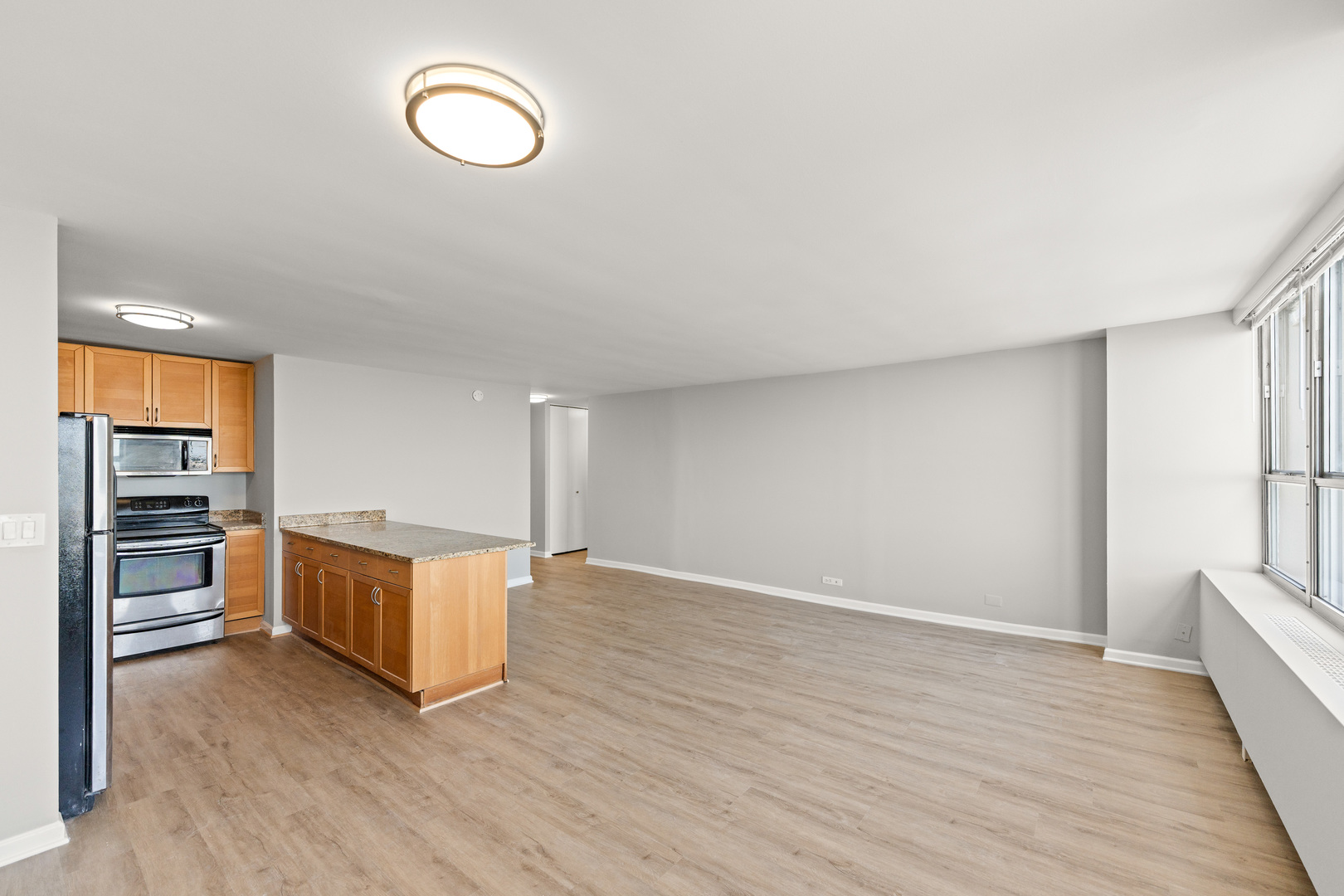 655 West Irving Park Road, Unit 5306 Chicago, IL 60613 - Photo 11 of 28 a view of a room with wooden floor and window