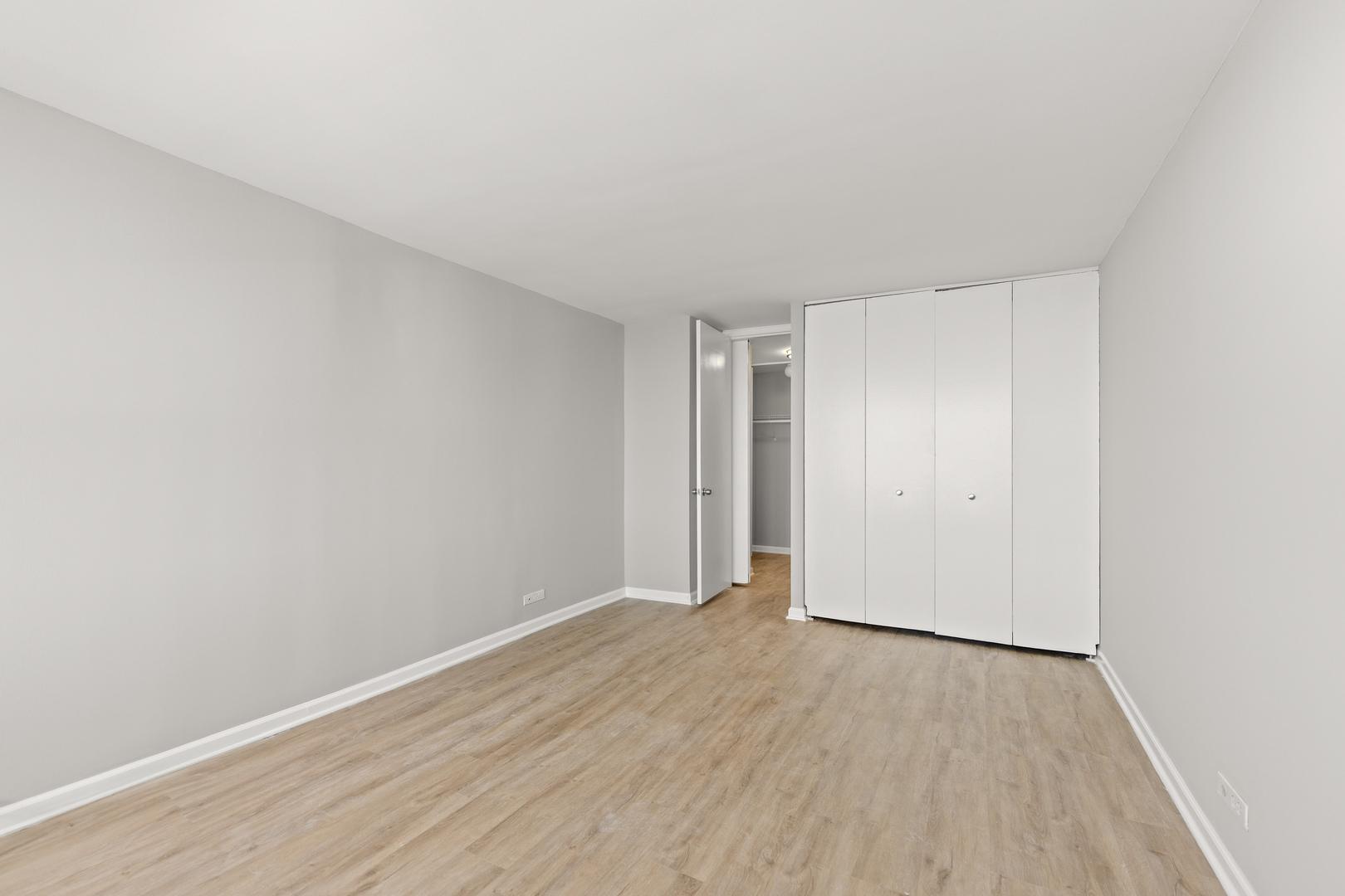 655 West Irving Park Road, Unit 5306 Chicago, IL 60613 - Photo 18 of 28 a view of an empty room and wooden floor