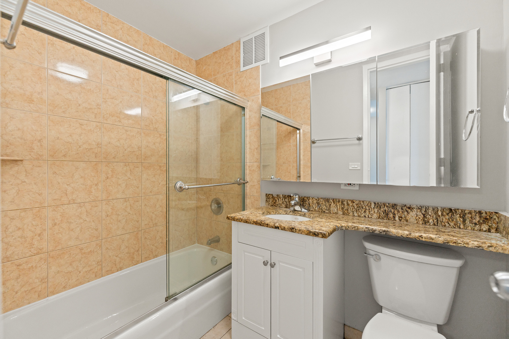 655 West Irving Park Road, Unit 5306 Chicago, IL 60613 - Photo 20 of 28 a bathroom with a sink and a mirror a toilet