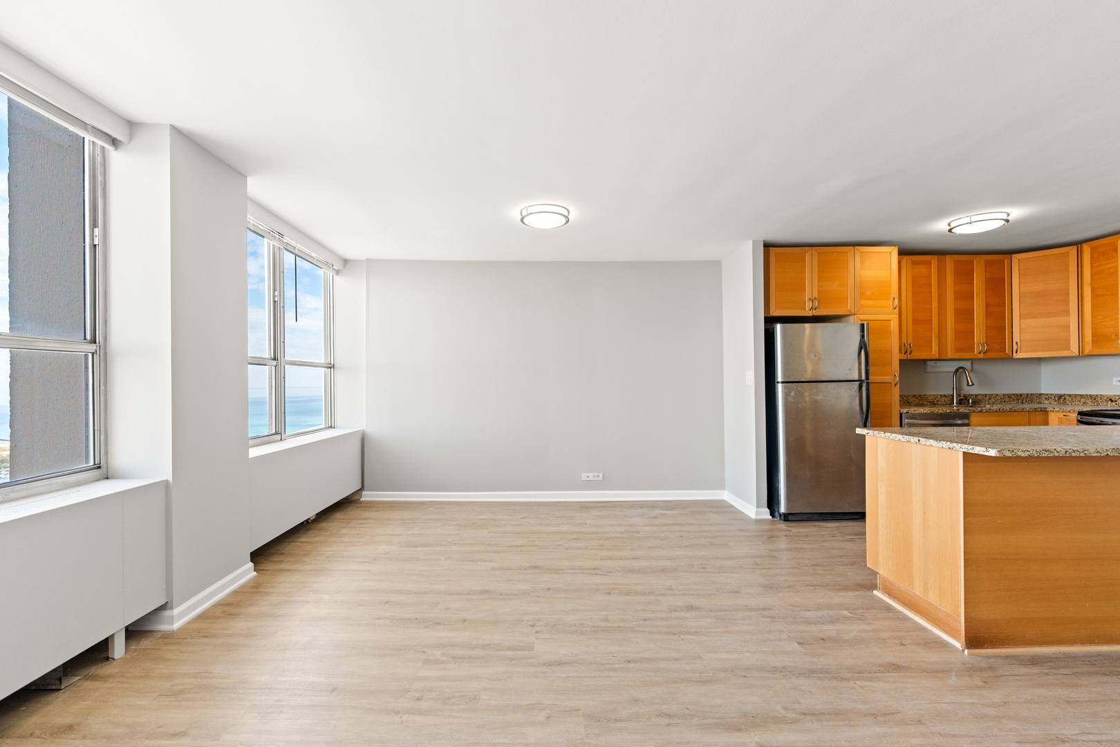 655 West Irving Park Road, Unit 5306 Chicago, IL 60613 - Photo 10 of 28 a view of a kitchen with wooden floor and a window