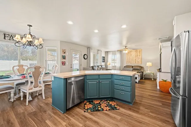 a kitchen with stainless steel appliances granite countertop a stove and a refrigerator