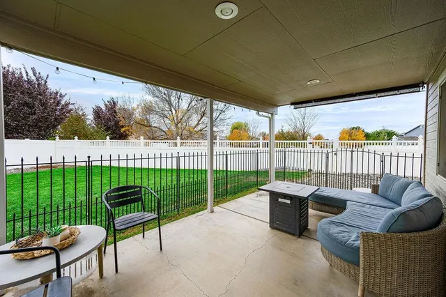 a view of a patio with couches chairs and a yard