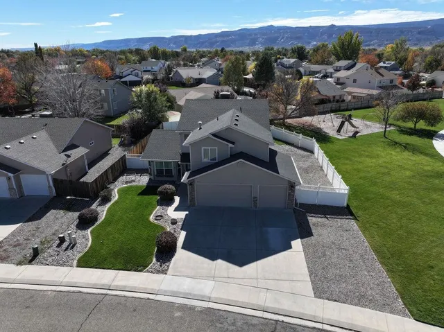 an aerial view of a house with a garden and trees