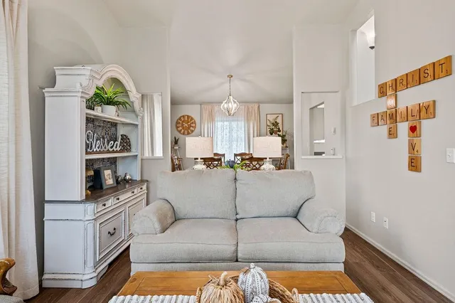 a living room with furniture fireplace and wooden floor