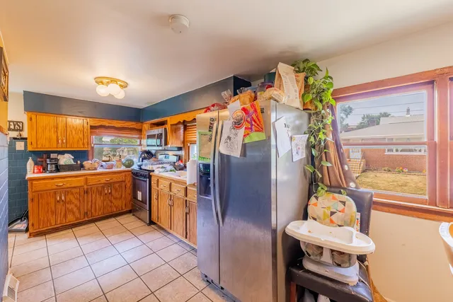 a kitchen with refrigerator and cabinets
