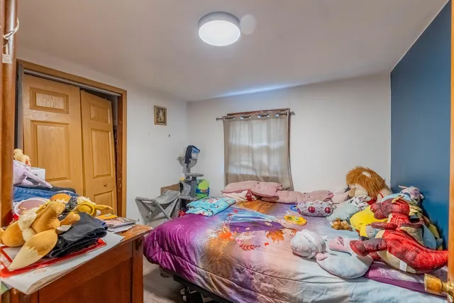 a bedroom with bed and a window