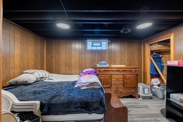 a bedroom with a bed and a walk in closet
