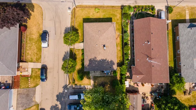 aerial view of a house with a yard and fountain in front of it