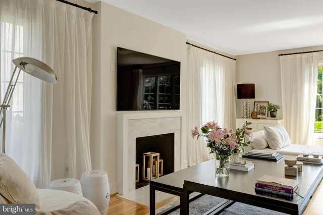 a living room with furniture fireplace and window