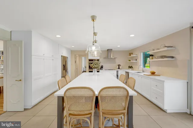 a bedroom with a large bed and a wooden floor