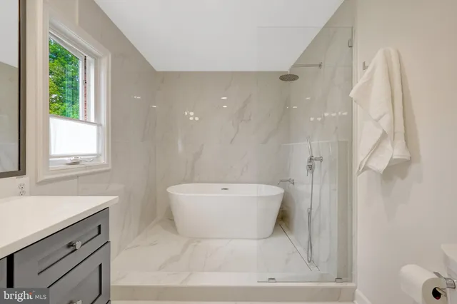 a front view of a house with swimming pool having outdoor seating