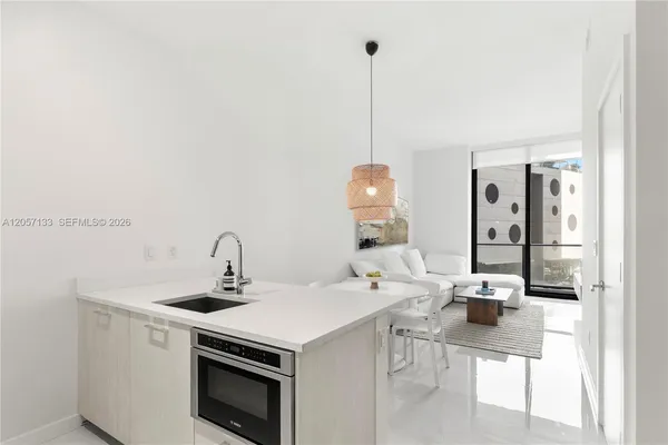 a kitchen with a sink a stove and chairs