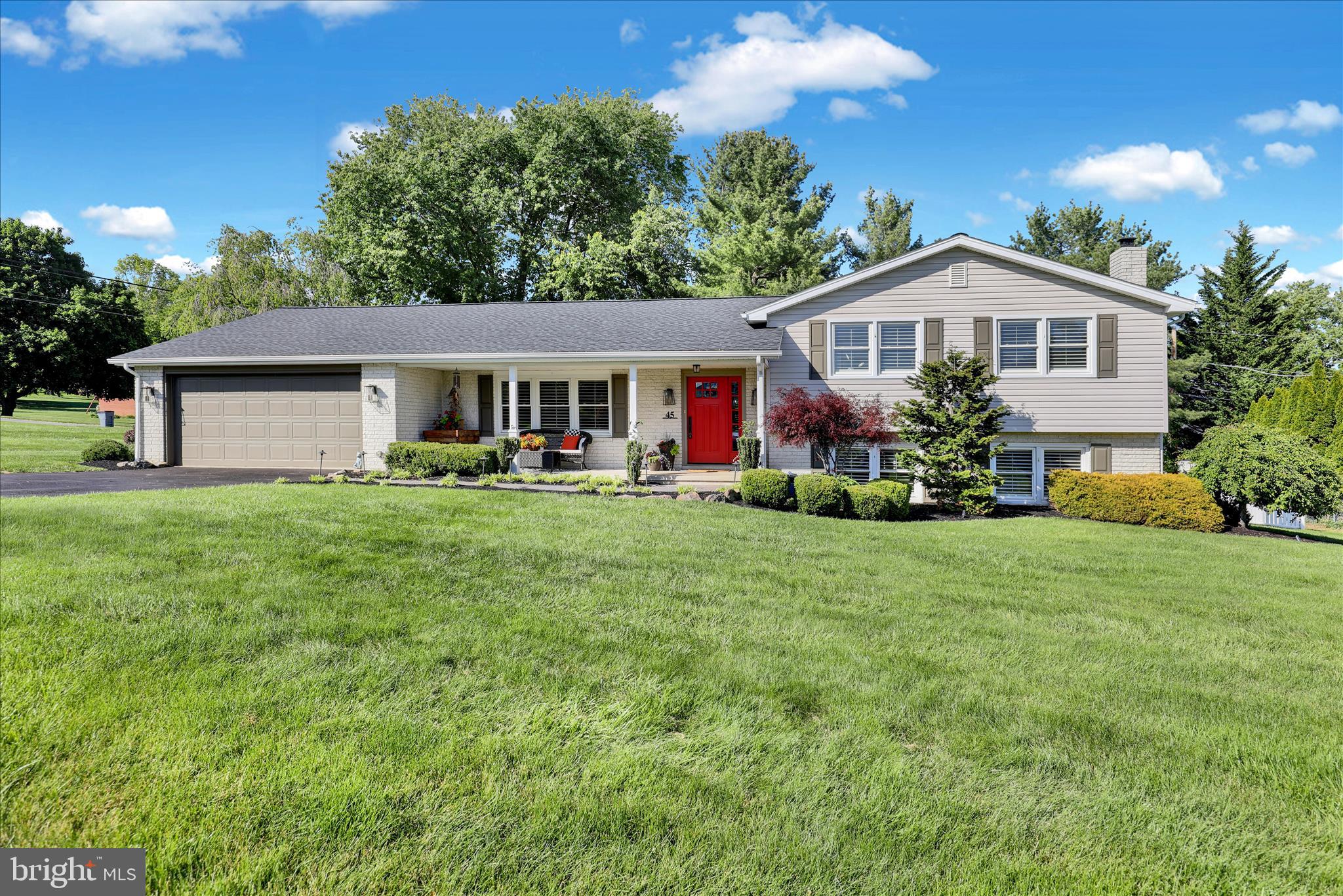 a front view of house with yard and green space