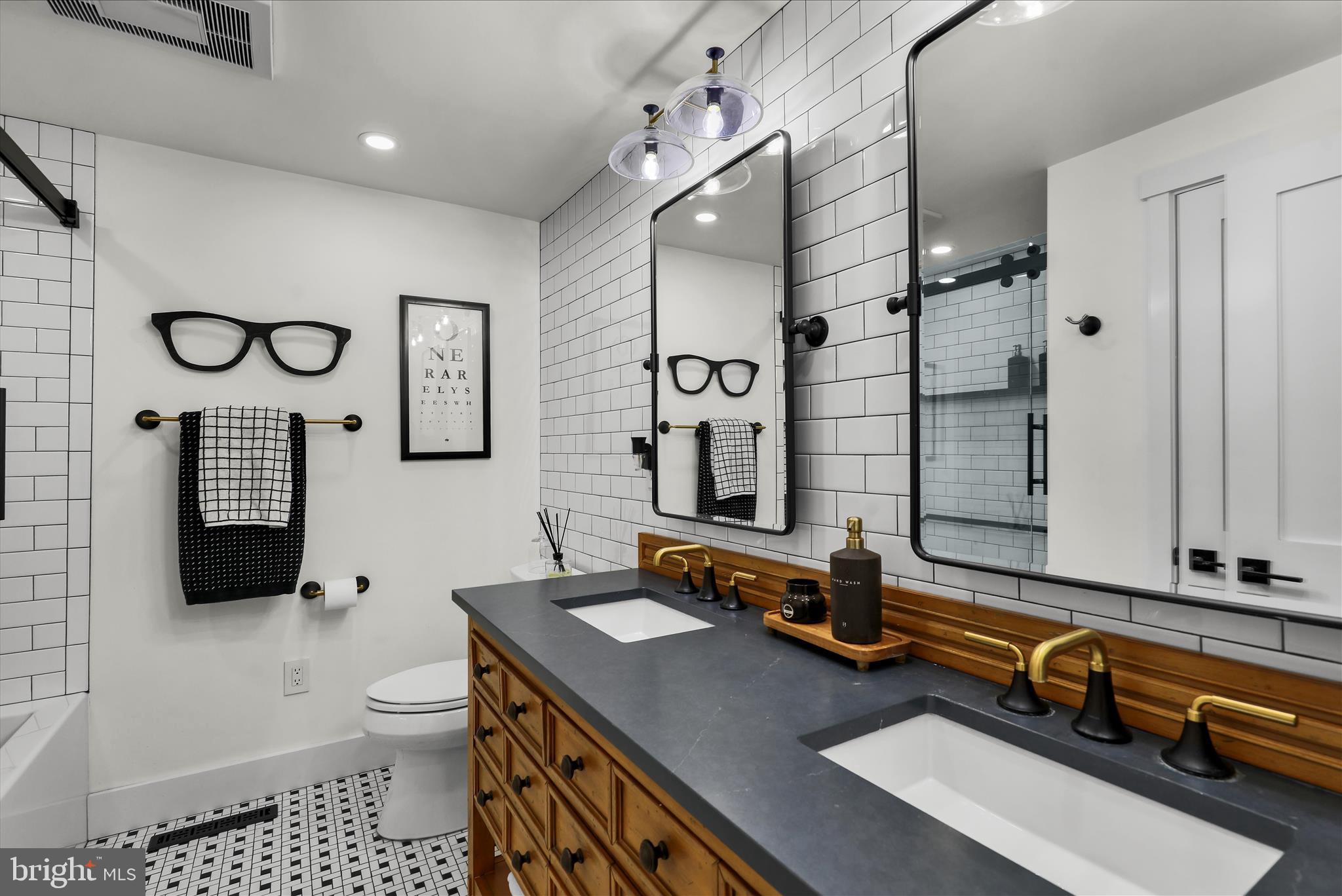 45 Mast Road Oley, PA 19547 - Photo 15 of 39 a bathroom with a sink a toilet a mirror and shower