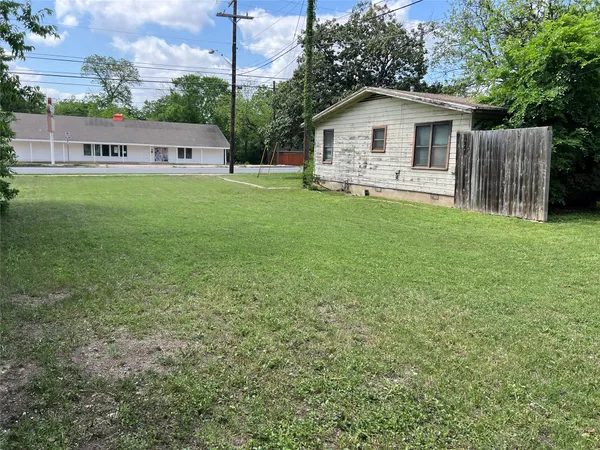 a view of a house with a yard and sitting area