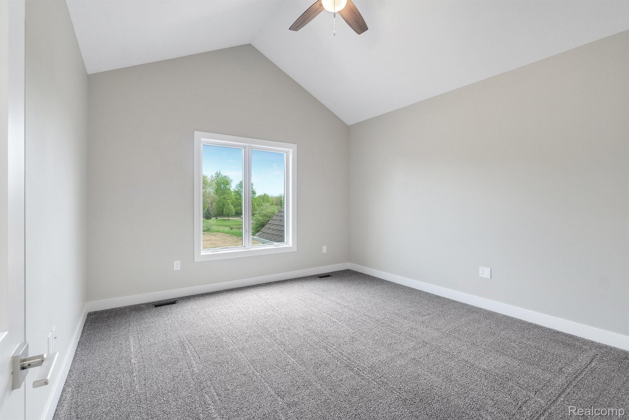 12240 Hibner Road Hartland, MI 48353 - Photo 26 of 37 Bedroom 2 on the second floor with vaulted ceiling