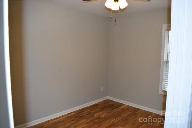 a view of a room with wooden floor