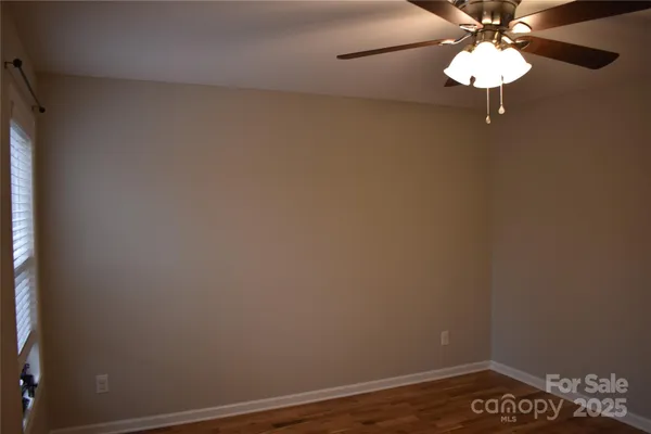 a view of wooden floor and windows in a room