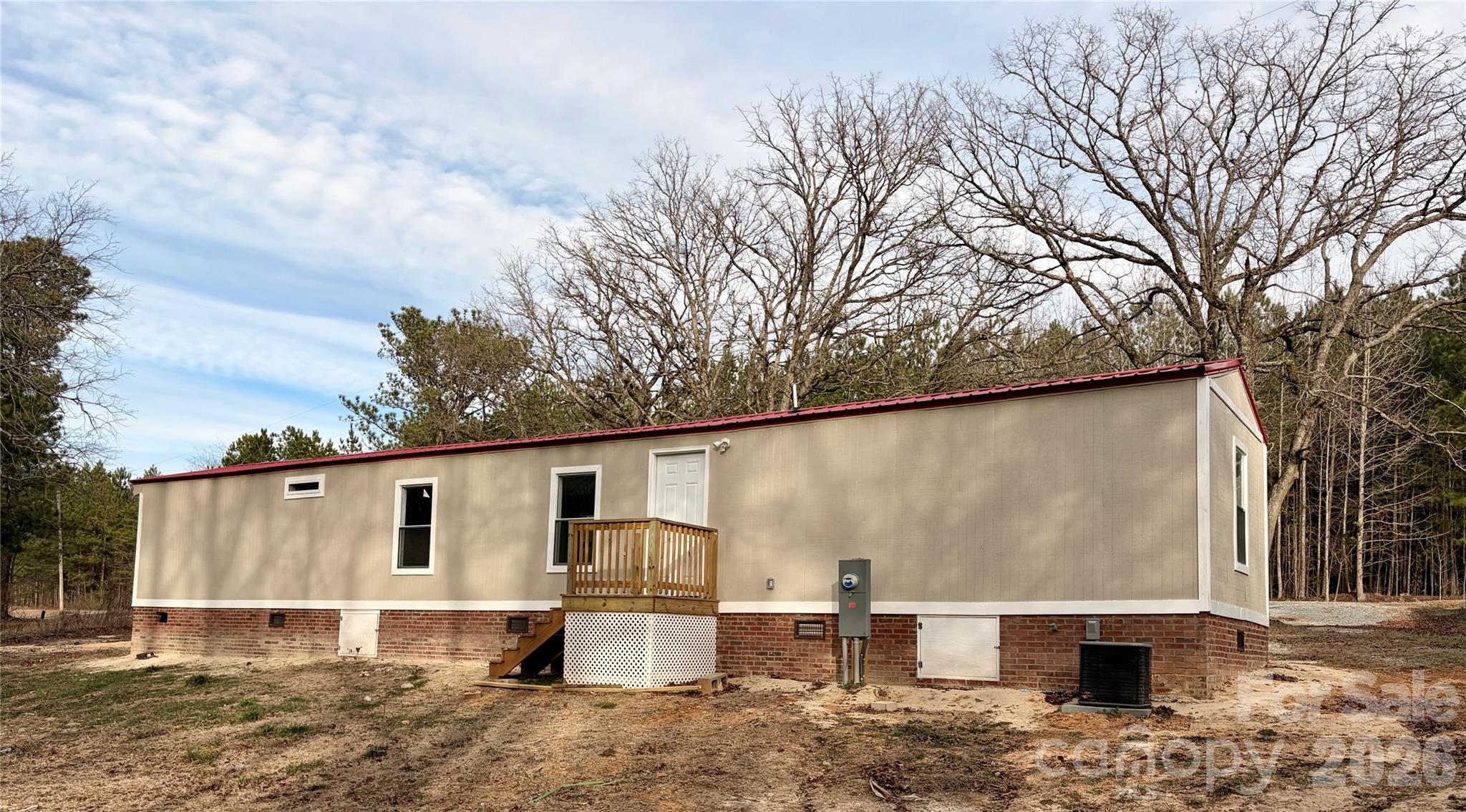590 Adams Road Morven, NC 28119 - Photo 3 of 15 a view of a white house with a big yard and large tree
