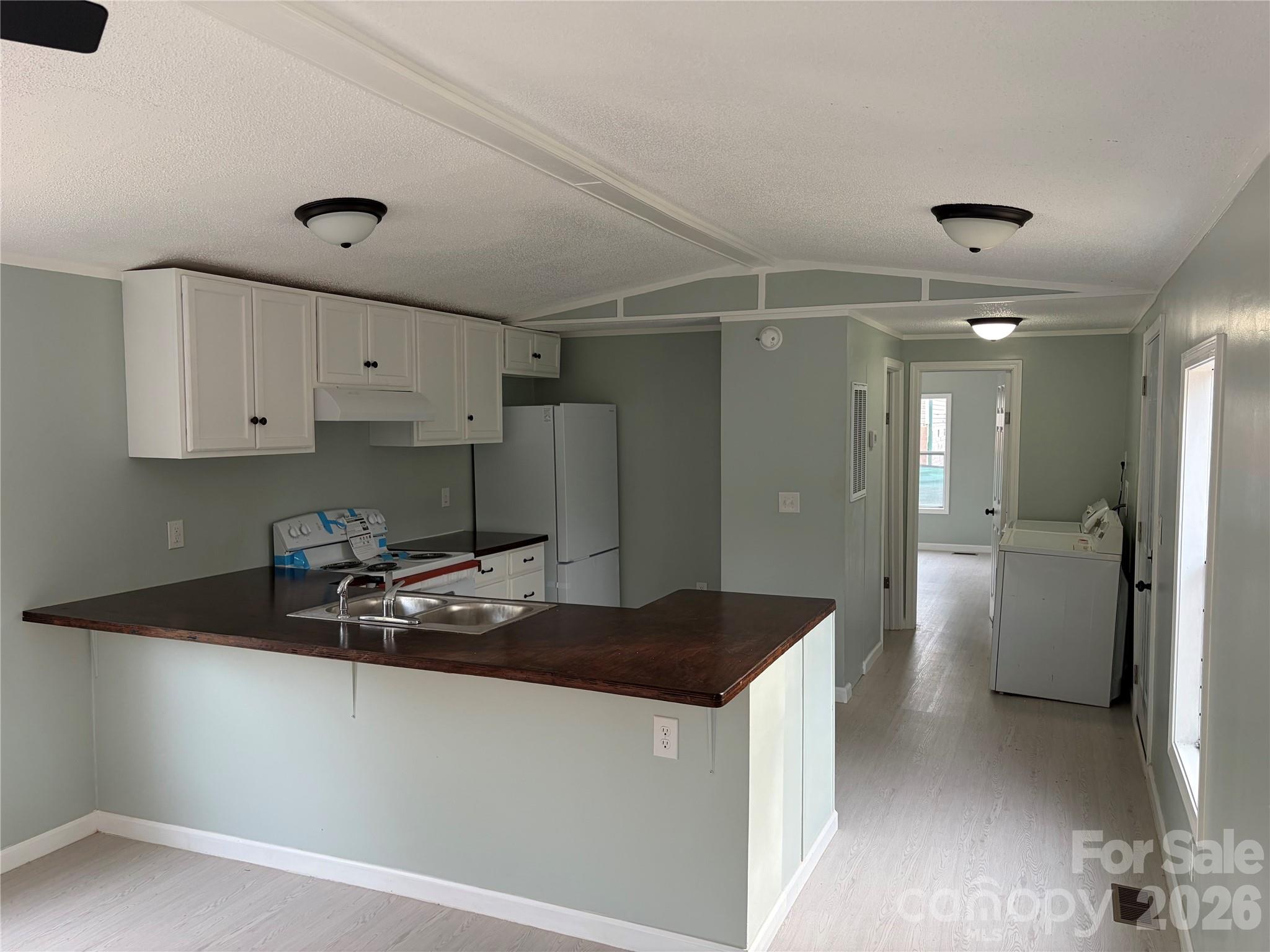590 Adams Road Morven, NC 28119 - Photo 4 of 15 a kitchen with a sink and refrigerator