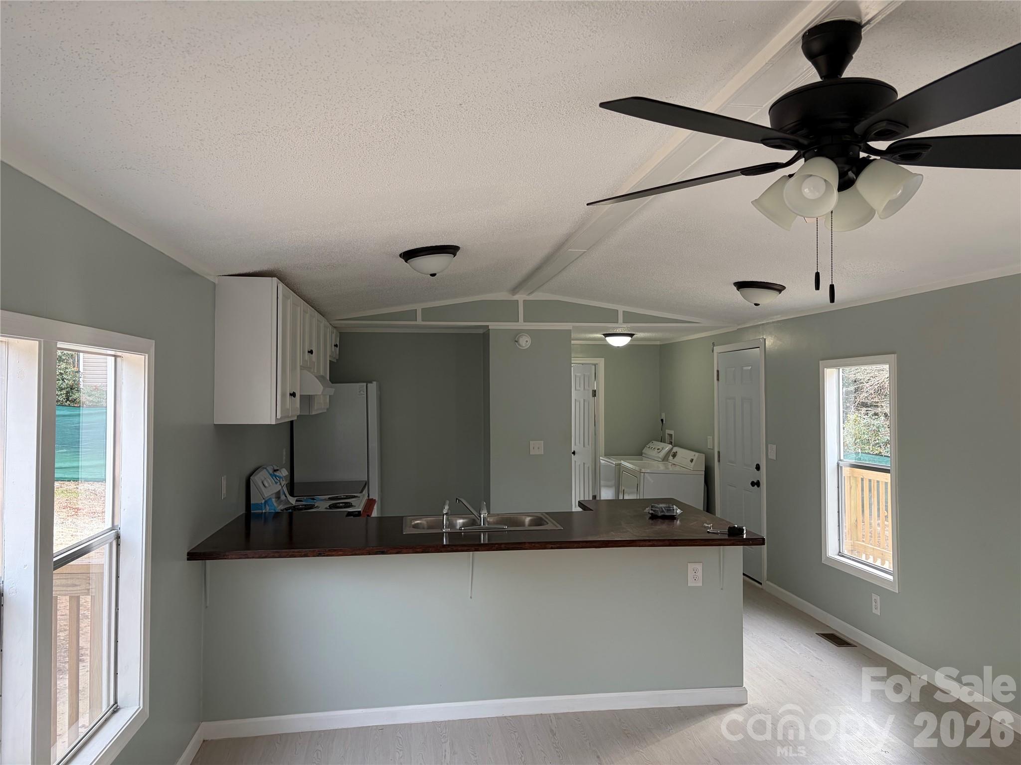 590 Adams Road Morven, NC 28119 - Photo 5 of 15 a large kitchen with a counter space a sink and appliances