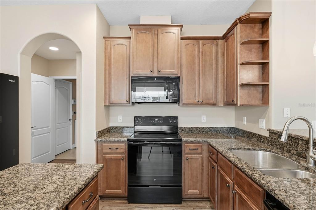 2506 West Ivy Street Tampa, FL 33607 - Photo 11 of 40 a kitchen with granite countertop a sink stove and cabinets