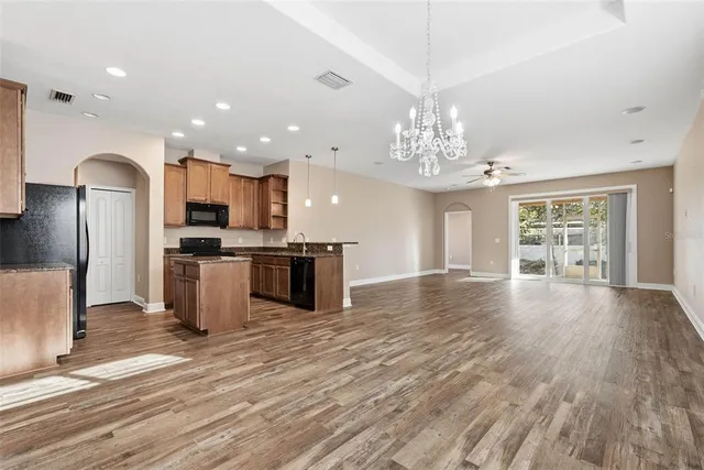 a view of a kitchen with cabinets and stainless steel appliances