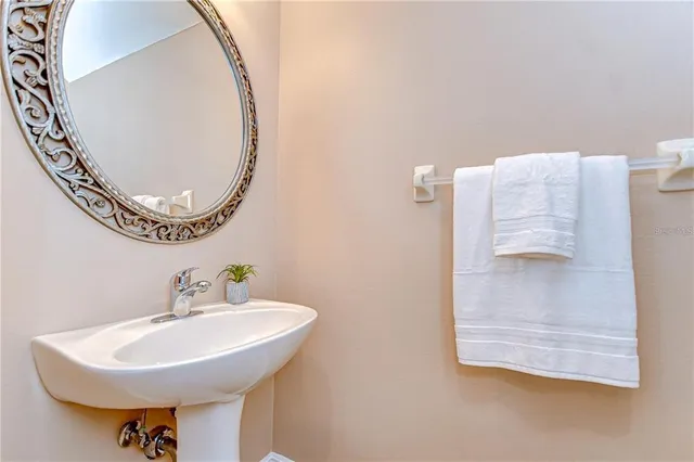 a bathroom with a sink a mirror and a toilet