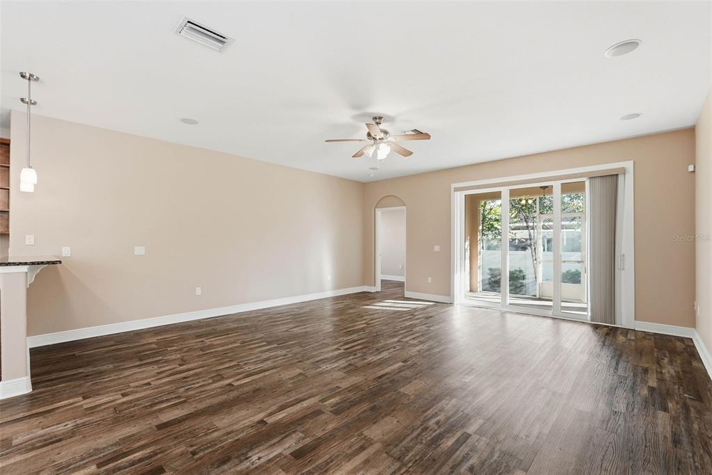 2506 West Ivy Street Tampa, FL 33607 - Photo 20 of 40 a view of an empty room with wooden floor and a window