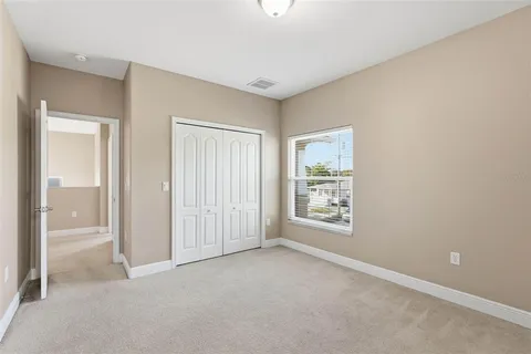 an empty room with windows and closet