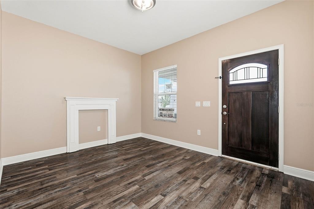 2506 West Ivy Street Tampa, FL 33607 - Photo 6 of 40 a view of an empty room with wooden floor and a window