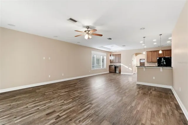 a view of a kitchen with cabinets and wooden floor