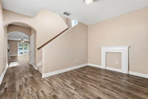 a view of a room with wooden floor and stairs