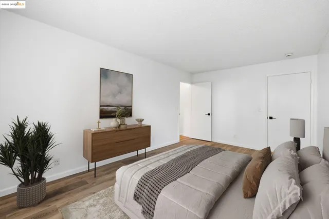 a bedroom with a bed and a potted plant