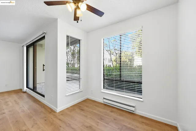 a view of a livingroom with a ceiling fan and window