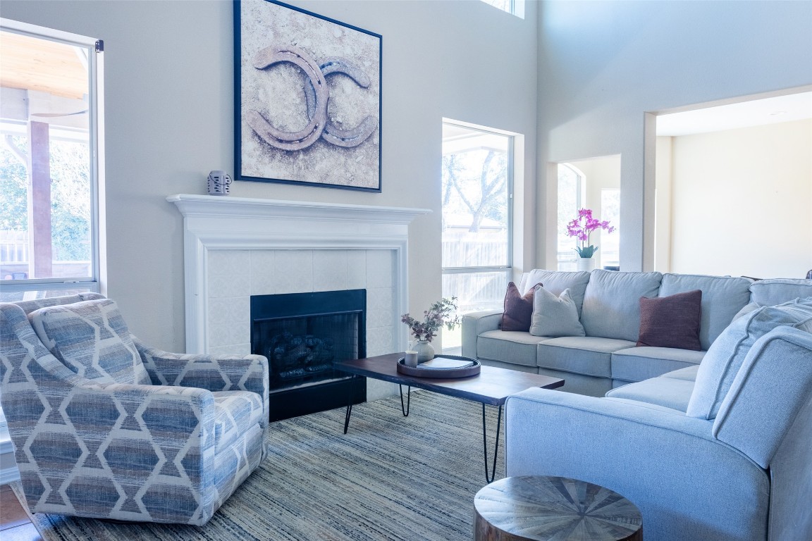 3113 Quail Run Round Rock, TX 78681 - Photo 11 of 29 Living area featuring a fireplace and a towering ceiling