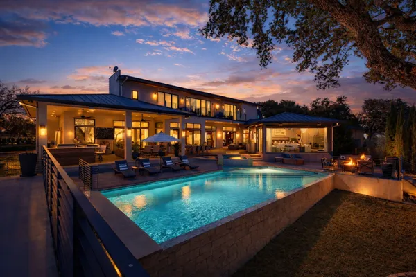 a view of a swimming pool with an outdoor seating and a yard