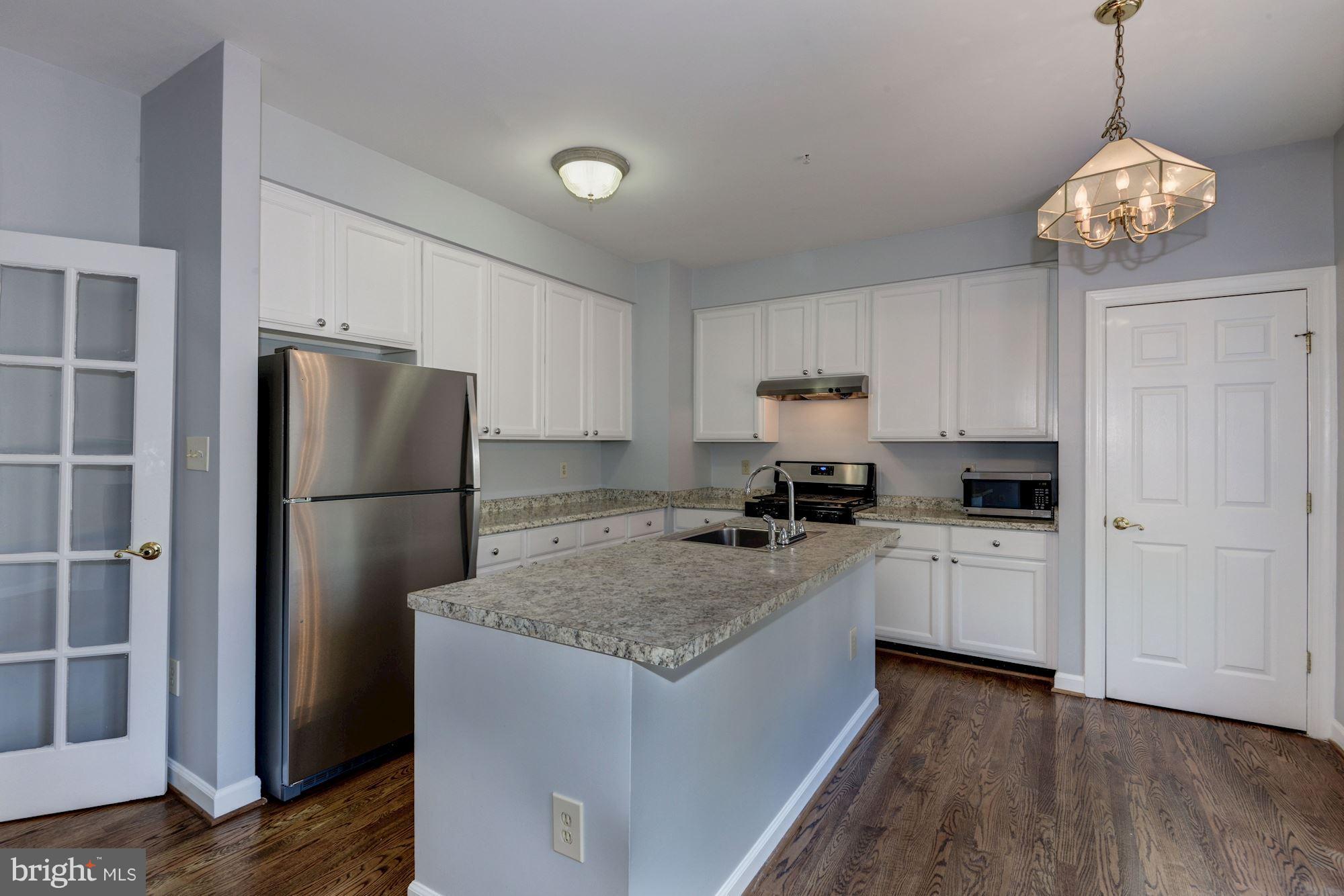 2101 Hounds Run Place Silver Spring, MD 20906 - Photo 12 of 30 a kitchen with a refrigerator sink and cabinets
