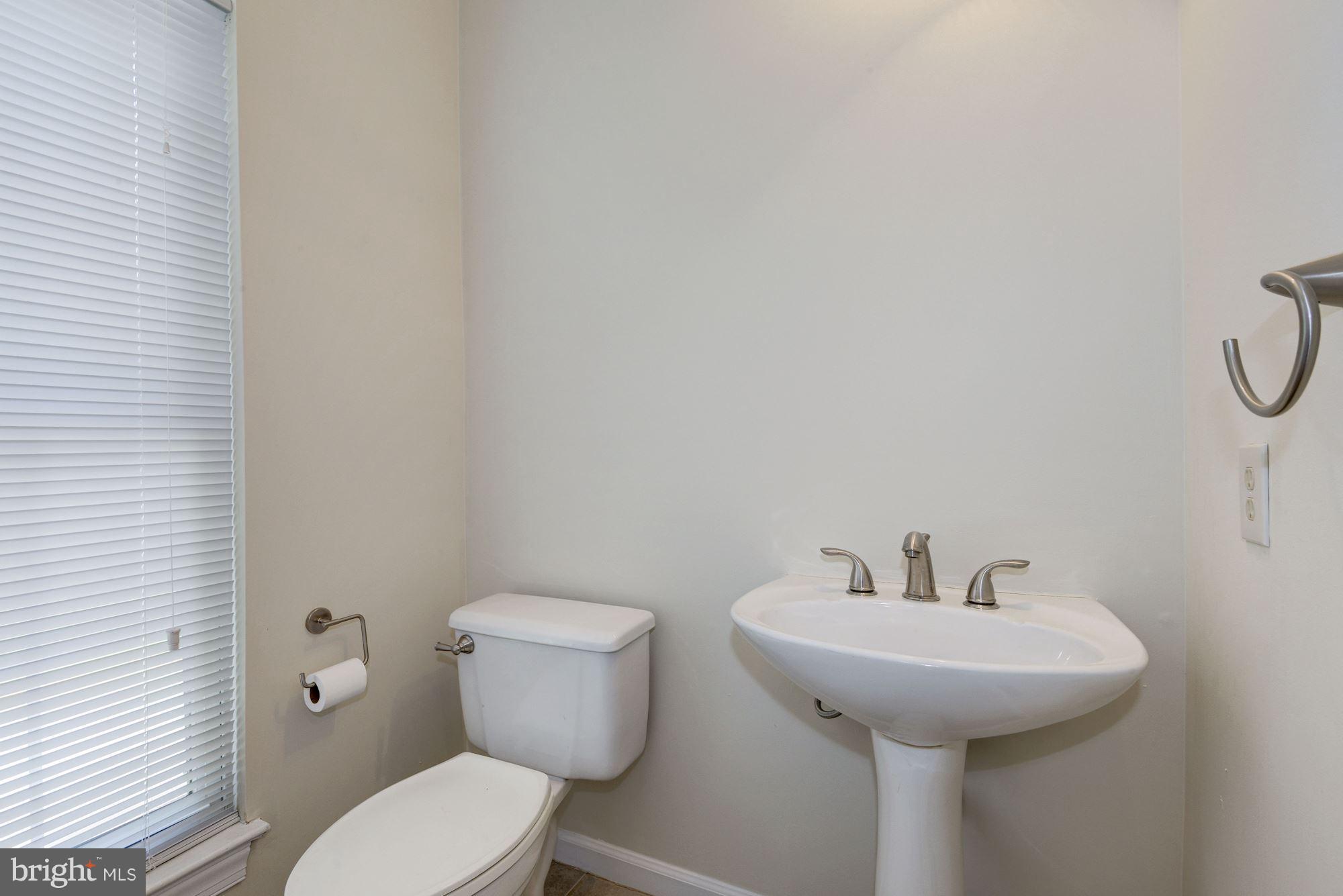 2101 Hounds Run Place Silver Spring, MD 20906 - Photo 15 of 30 a bathroom with a toilet sink and mirror