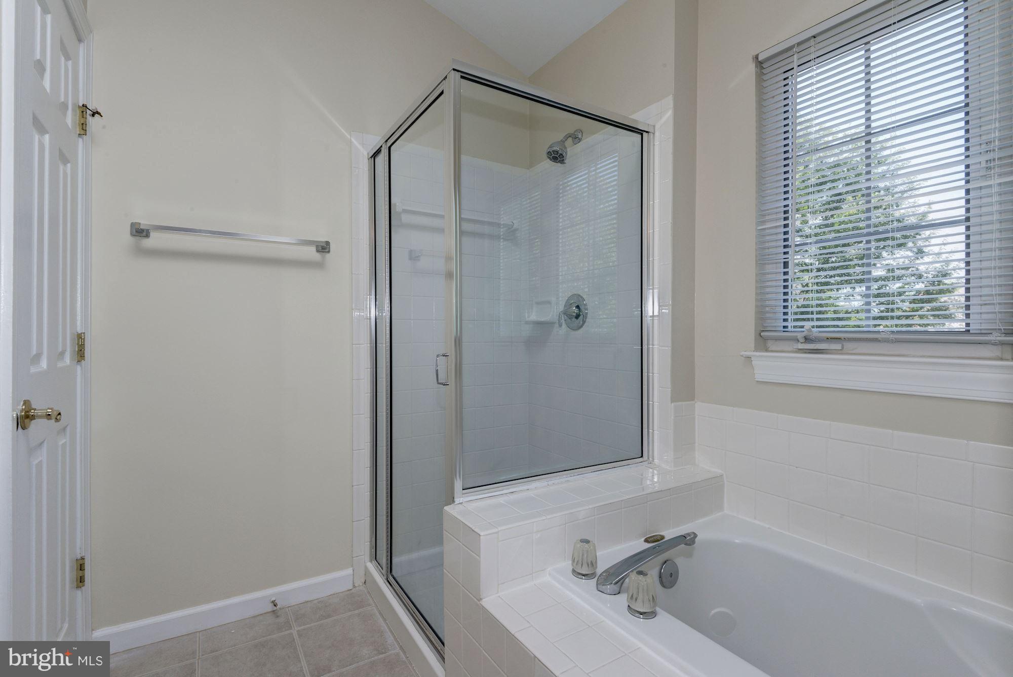 2101 Hounds Run Place Silver Spring, MD 20906 - Photo 20 of 30 a bathroom with a bathtub and a shower