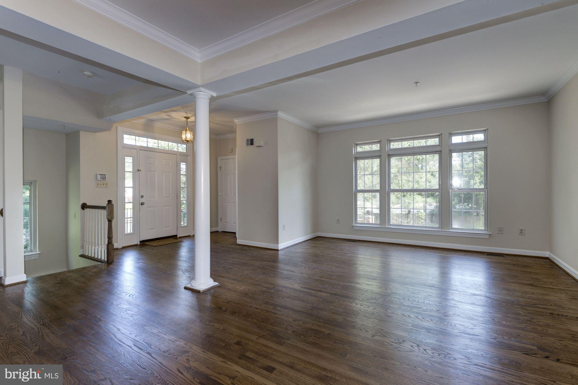 2101 Hounds Run Place Silver Spring, MD 20906 - Photo 3 of 30 an empty room with large windows and wooden floor