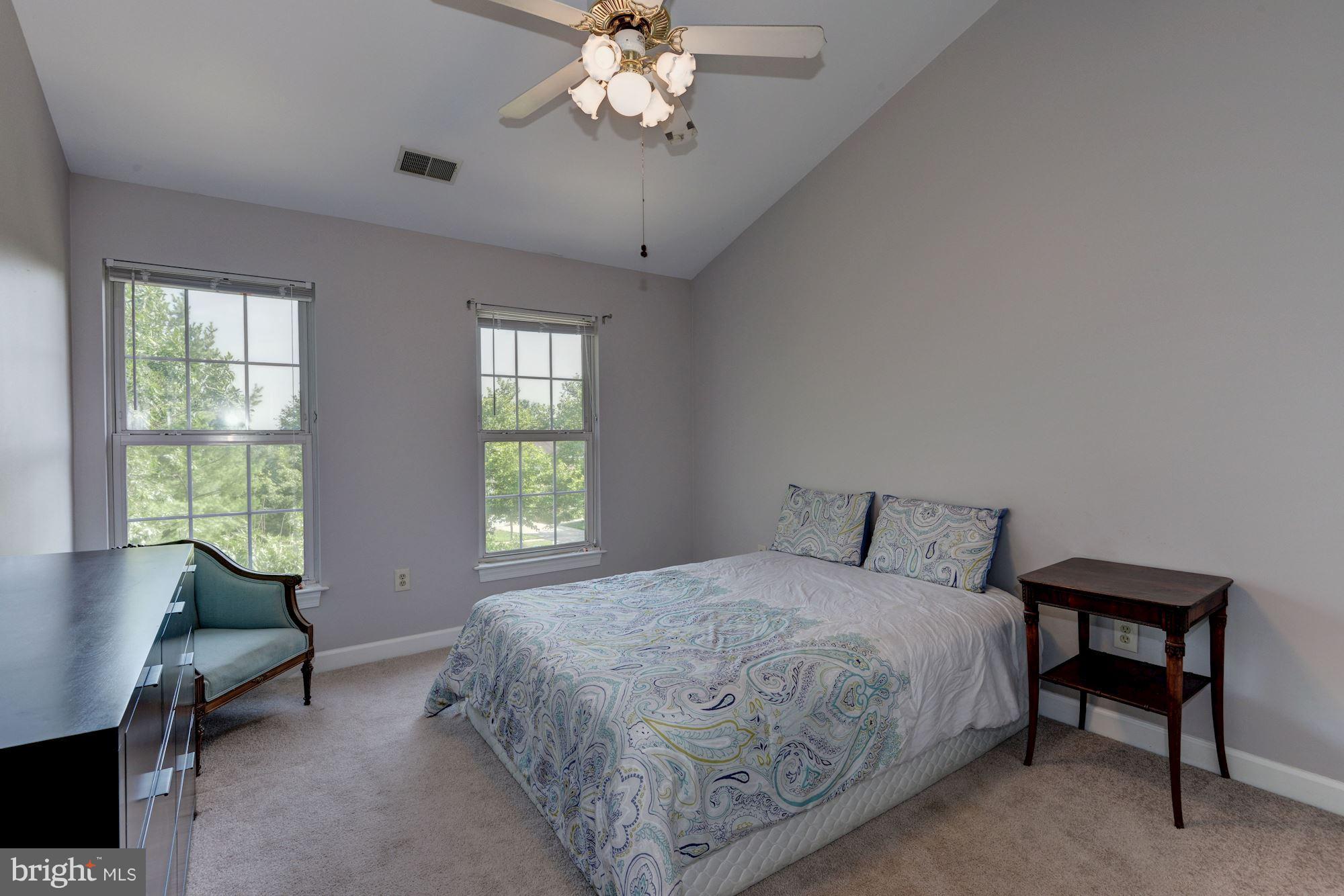 2101 Hounds Run Place Silver Spring, MD 20906 - Photo 22 of 30 a bedroom with a bed table chair and a window