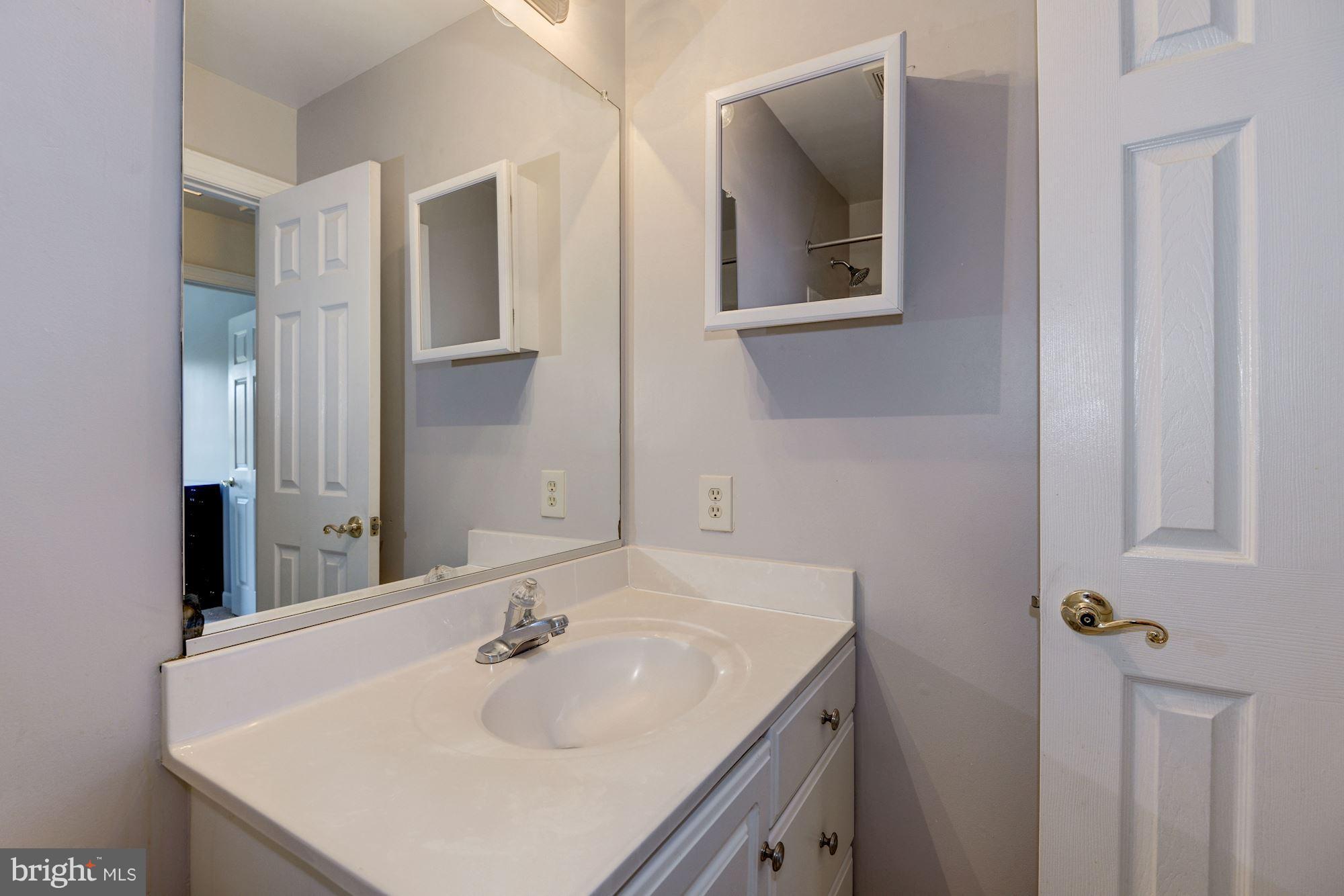 2101 Hounds Run Place Silver Spring, MD 20906 - Photo 24 of 30 a bathroom with a sink and a mirror