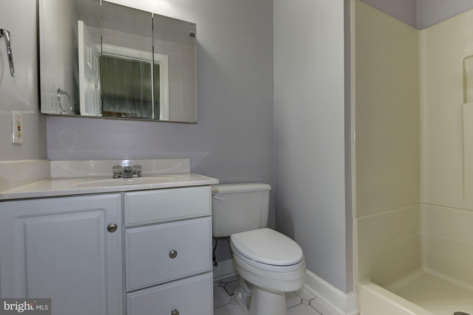 2101 Hounds Run Place Silver Spring, MD 20906 - Photo 28 of 30 a bathroom with a toilet sink and mirror